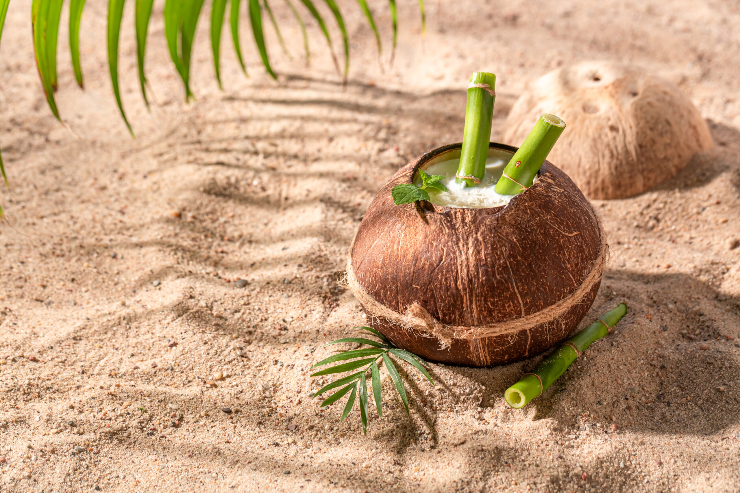Delicious and healthy pinacolada in coconut on tropical beach. Holidays on a paradise beach.